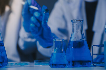 chemist,scientist hand dropping chemical liquid into test tube, science research and development concept