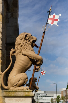 SOUTHAMPTON, UK - MAY 12, 2024: Lion statue with the flag of England beside Bargate in the city centre