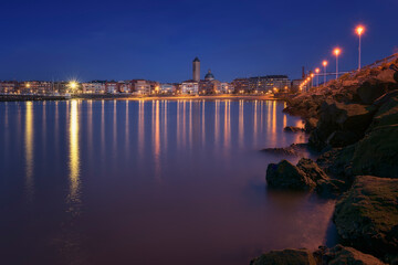 Dusk skyline of Las Arenas, Getxo, with the Las Mercedes church standing out and the reflection of...