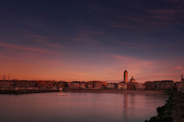Dusk skyline of Las Arenas, Getxo, with the Las Mercedes church standing out and the reflection of...