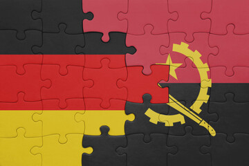 puzzle with the colourful national flag of angola and flag of germany.