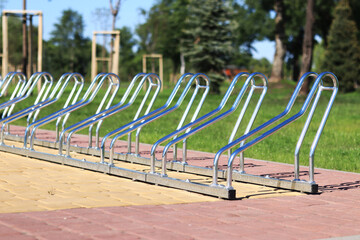 Parking for bicycles in the park. Metal structure for parking bicycles close-up. Bicycle parking on...