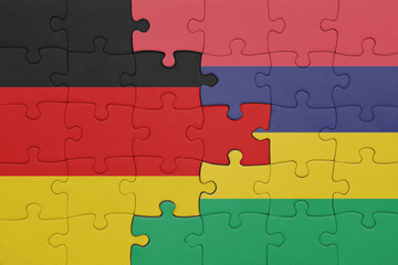 puzzle with the colourful national flag of mauritius and flag of germany.