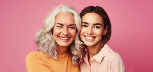 Portrait of happy smiling mature mother and adult daughter, two women together on studio background