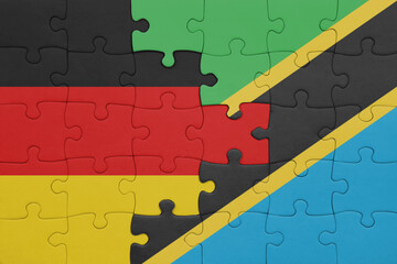 puzzle with the colourful national flag of tanzania and flag of germany.