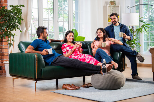 Indian asian young couple having coffee together at home
