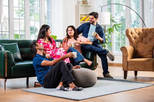 Indian asian young couple having coffee together at home