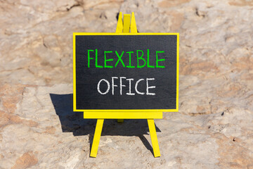 Fototapeta premium Flexible office symbol. Concept words Flexible office on beautiful yellow blackboard. Beautiful red stone beach background. Business Flexible office concept. Copy space.