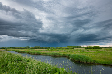 Dramatic looking cloudscape as a thunderstorm passes over the ¨Bentwoud¨ nature reserve in the west of the Netherlands.