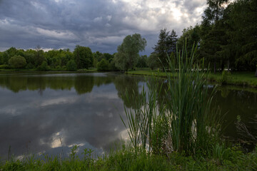 Pond under dramatic skies before nightfall