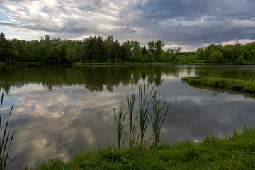 Pond under dramatic skies before nightfall