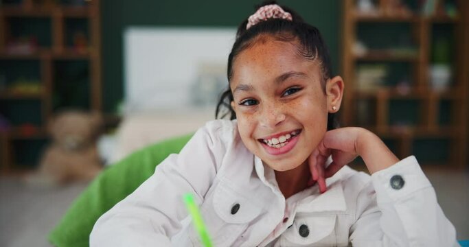 Girl, home and homework with book and face in bedroom, child and student writing and studying or learning. Childhood, development and growth or school assessment, workbook or education for knowledge