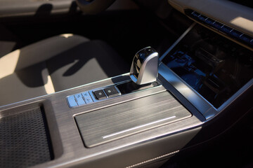 Detailed view of luxury vehicle dashboard with shifter and buttons