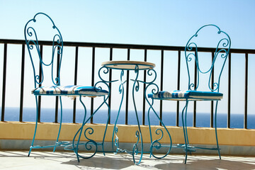 Beautifully stylish table chairs on the sea shore background