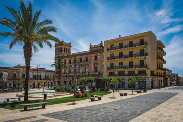 Main square known as Piazza Unit d'Italia in Ispica, a charming town in south-eastern Sicily, under an intensely blue sky. June 2023