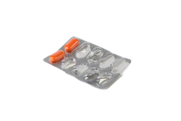 Blister with two orange tablets on a white background.