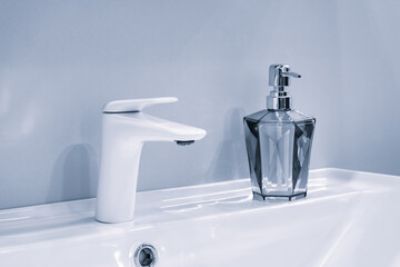 A bathroom sink with  faucet and a white countertop