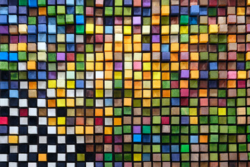 A colorful mosaic made of wood blocks. The blocks are arranged in a way that creates a pattern of...