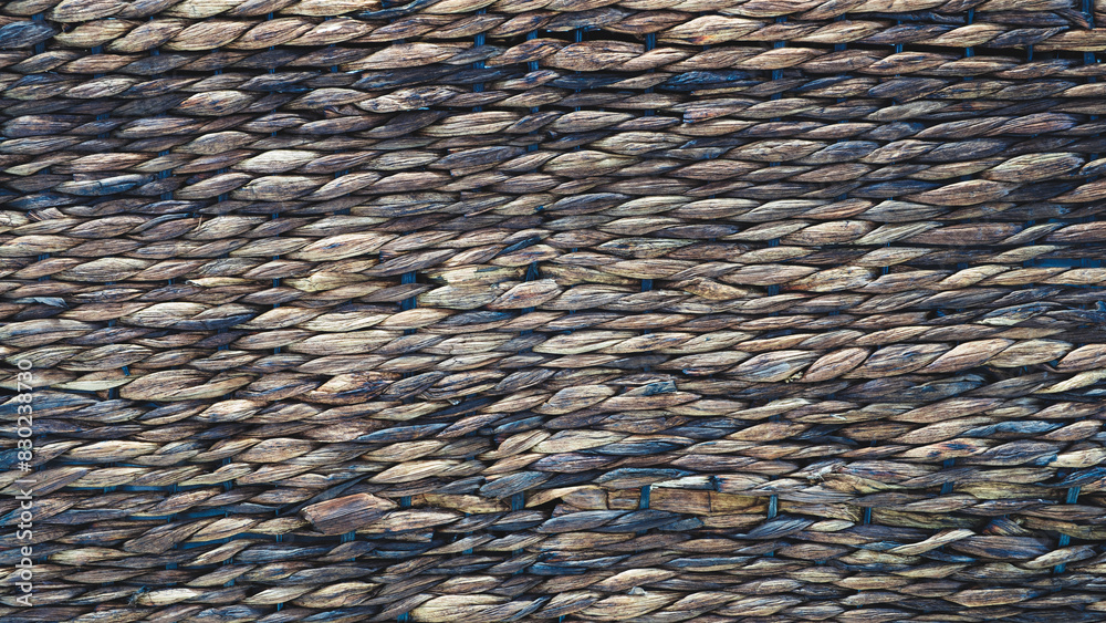 Poster a close up of a wall made of brown and tan stones. the wall is made up of many small stones, and the