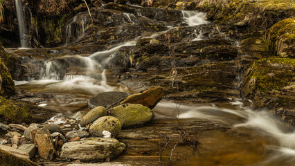 A small stream with stones.