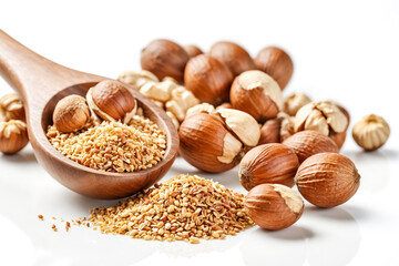 Close up of hazelnuts and chopped hazelnuts on white background