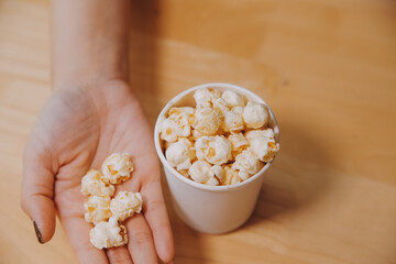 A woman holding a bowl of popcorn