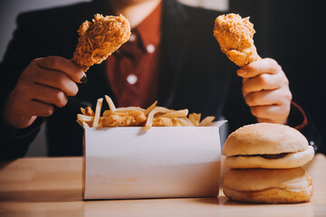 close up focus woman hand hold fried chicken for eat,girl with fast food concept