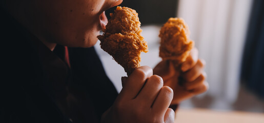 close up focus woman hand hold fried chicken for eat,girl with fast food concept