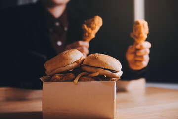 close up focus woman hand hold fried chicken for eat,girl with fast food concept