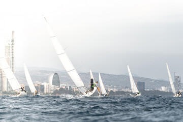 Sailing regatta with city skyline in background