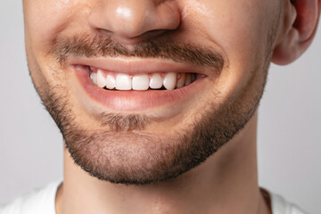 Fototapeta premium portrait of a mature man smiling, smile with perfect teeth, closeup on lips of a man, dental care, dentist advertising