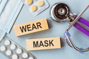 Wear Mask Reminder With Medical Supplies on a Light Blue Background