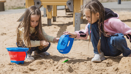 Childs playing sand on playground.