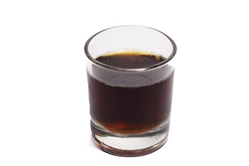 a glass of fizzy cola drink isolated on white