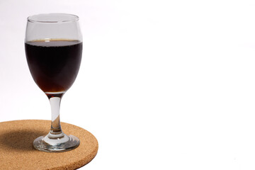 a glass of fizzy cola drink isolated on white