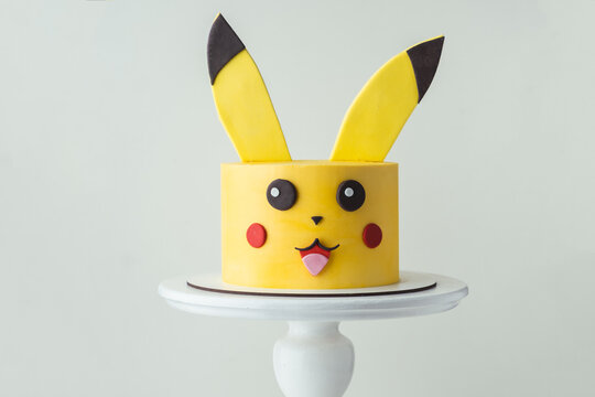 KYIV, UKRAINE - January 26: Pikachu yellow birthday cake on the white background. Character Pikachu from Pokemon Go Game