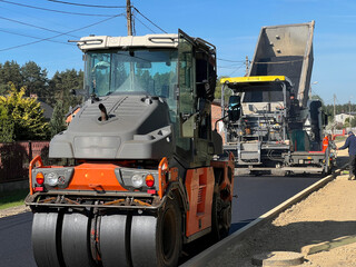 Construction of a new street surface. Laying a layer of asphalt with a specialized machine