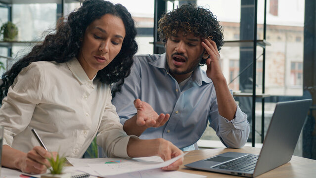 Professional mentor Arabian businesswoman help teach Indian worker analysis explain web project laptop difficult business quarrel conflict misunderstanding teamwork woman man use computer at office