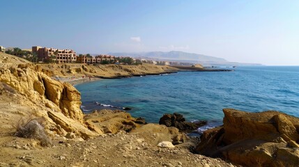 A beach with a rocky shoreline and a clear blue ocean