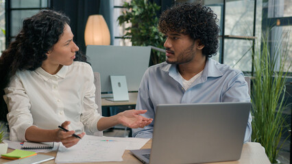 Arabian businesswoman mentor explain financial data teach employee consult trainee help with web...