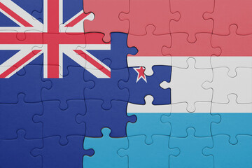 puzzle with the colourful national flag of luxembourg and flag of new zealand.