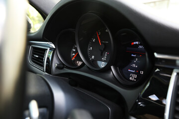 Fototapeta premium Speedometer and tachometer inside of modern car, closeup