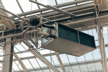 Naklejka premium Industrial air conditioning handling unit suspended on frame construction under ceiling