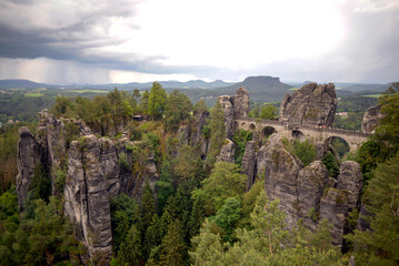 Obraz premium Bastei Bridge (Basteibrücke) with approaching thunderstorm in Saxony, Germany