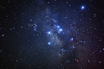 Fototapeta premium Starry sky with a cluster of stars and a bright blue star