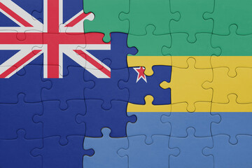 puzzle with the colourful national flag of gabon and flag of new zealand.