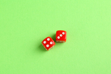 Two red game dices on green background, flat lay