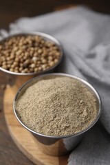 Ground pepper and peppercorns on wooden table, closeup