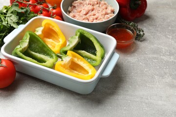 Making stuffed peppers. Vegetables and ground meat on grey table