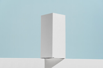 White mockup box for syrup, tablets or mouthwash with drop shadow on blue background. The concept of pharmacy, advertising of goods, medicines and dietary supplements